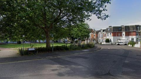 A Google Street View of Boscombe Crescent, a crescent-shaped road off Christchurch Road with a park in the middle.