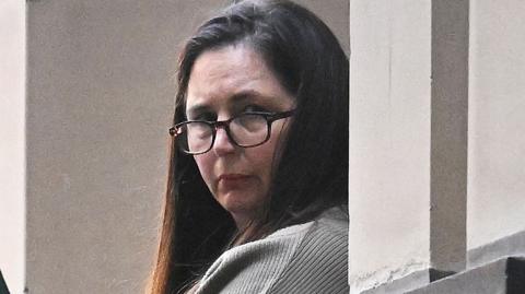 Erin Patterson during trial in Melbourne wearing glasses and her dark her down.