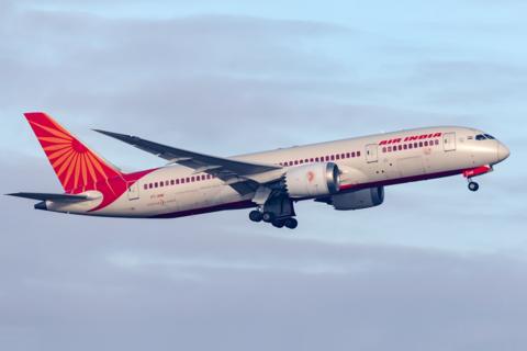 a boeing 787-8 dreamliner taking off with air india branding