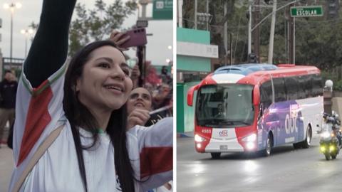 Players cheer as a bus carrying the Iranian football team arrives