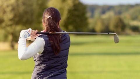 Woman playing golf