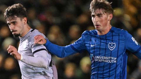 Portsmouth defender Hayden Matthews challenges for the ball against Millwall