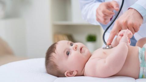 Baby being checked by a paediatrician