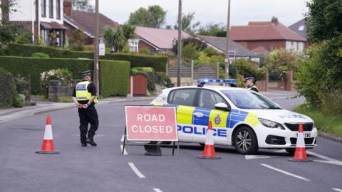 Police vehicle at crash scene on A61