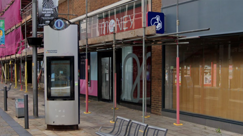 The front of the Virgin Money branch on Queen's Street in Wolverhampton covered with scaffolding. Next door to it is a Nationwide branch