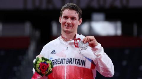 Daniel Bethell with his silver medal on the podium at the Tokyo Paralympics