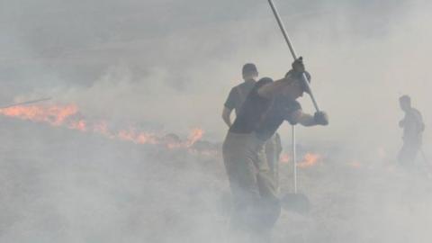 Firefighters fighting moorland fire