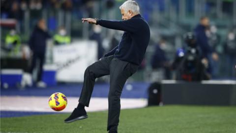 Jose Mourinho kicking the ball into crowd