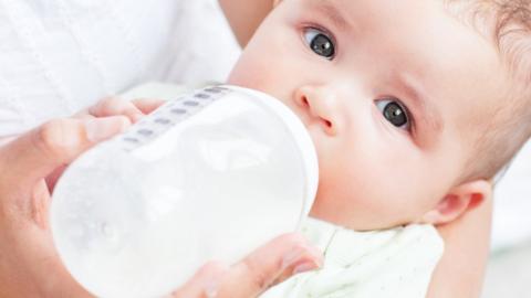 Baby drinking bottle of milk