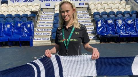 Aimee Broughton holding the scarf