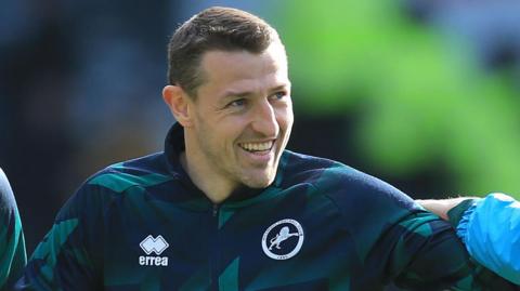 Defender Murray Wallace has joined Huddersfield from Millwall 