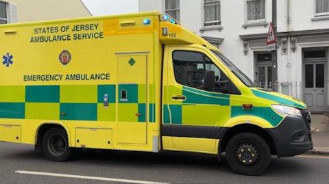 Ambulance driving on a road in Jersey