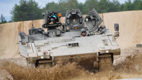 An Ajax Ares tank, an armored personnel carrier, on the training range at Bovington Camp
