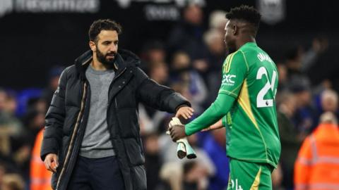 Manchester United's Portuguese head coach Ruben Amorim (L) shakes hands with Manchester United's Cameroonian goalkeeper #24 Andre Onana (R) at the end of the English Premier League football match between Ipswich Town and Manchester United at Portman Road