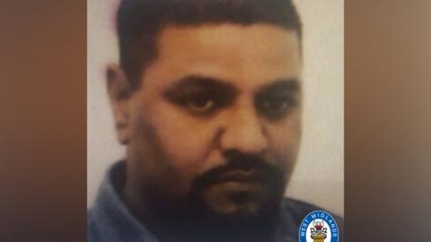 A faded image of Zafar Medhi shows him with dark cropped hair and a dark moustache and beard