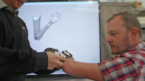 Paul tries on the bionic arm interface