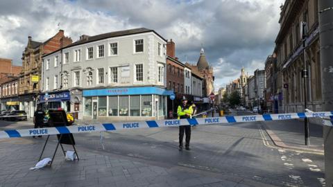 A police officer inside a cordon in Leicester city centre
