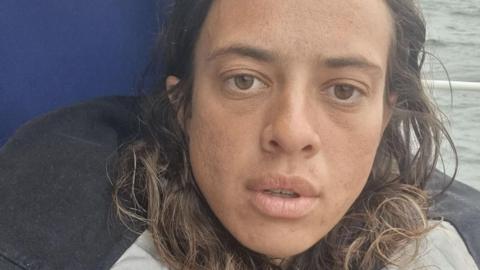 A close up image of Jazz Turner looking to camera looking sad on her yacht