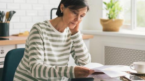 Woman looking at energy bill