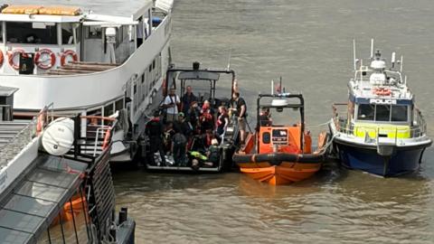 Rescue boats and a Met Police boat next to each other in the Thames.