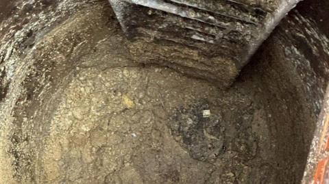 Ladder into a sewer where a fatberg is blocking the pipe.