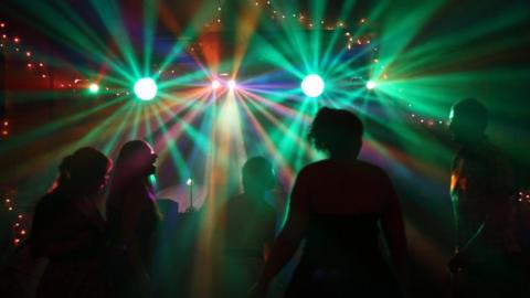 Customers dancing in a nightclub