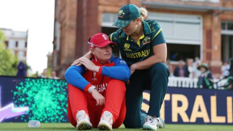 Sophie Ecclestone is consoled by Georgia Voll