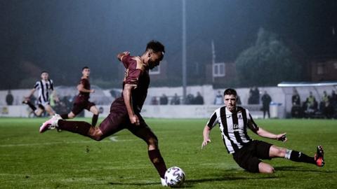 Player for Bury AFC kicking the football