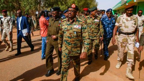Sudan military council member General Jamal Omar, centre