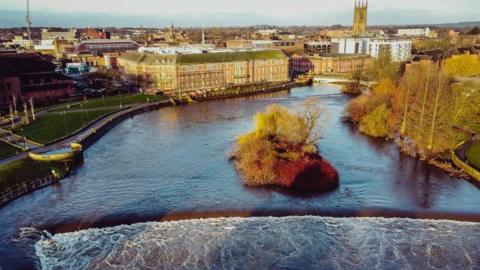 A swollen Derwent passing through the centre of the city viewed from above