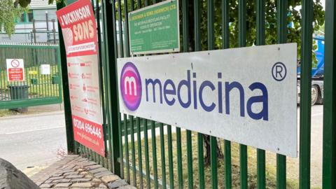 The green gate to the entrance of manufacturer Medicina Ltd in Blackrod, Bolton, which provides neonatal medical devices.