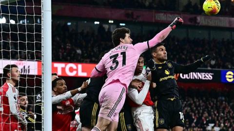Manchester United goalkeeper Senne Lammens goes to punch the ball out of his penalty area during the 3-2 win against Arsenal at the Emirates Stadium