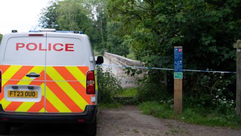 Police van outside crime scene