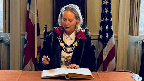 A woman dressed in civic regalia