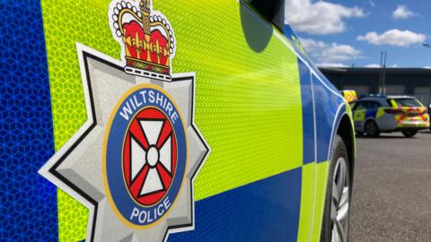 Generic picture of the side of a Wiltshire Police car, a close-up showing the force logo.