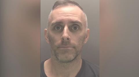 A mugshot of Scott Cameron 