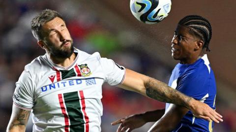 Ollie Palmer of Wrexham and Andrey Santos of Chelsea battle for the ball