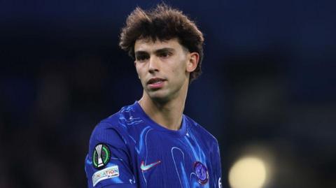 Joao Felix wearing a blue Chelsea shirt