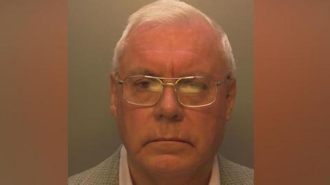 An elderly man with glasses. 