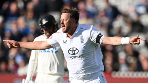 England bowler Ollie Robinson celebrates taking a wicket
