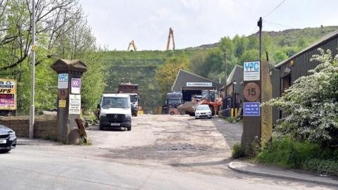 The former Bowling Iron Works site in Bradford, with industrial vehicles parked in the entrance and construction work under way in the background