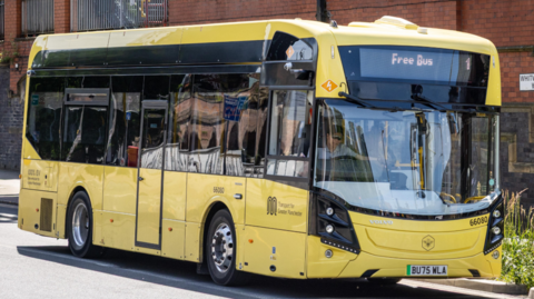 A yellow Bee Network bus.