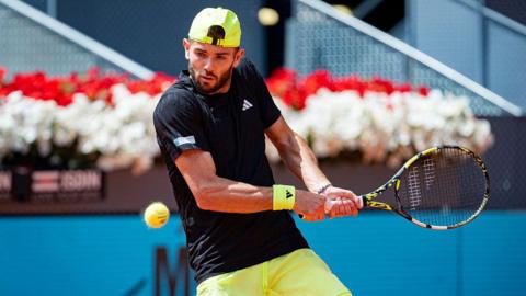 Jacob Fearnley prepares to strike the tennis ball 
