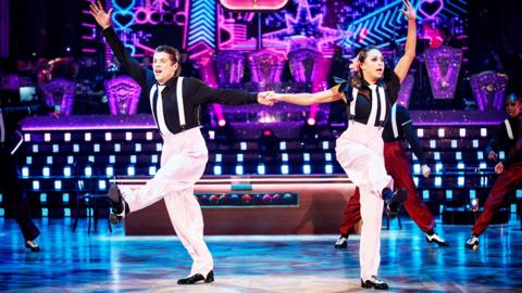 Lewis Cope & Katya Jones wearing mime outfits and dancing a Charleston on the Strictly Come Dancing Stage. Credit: BBC/Guy Levy