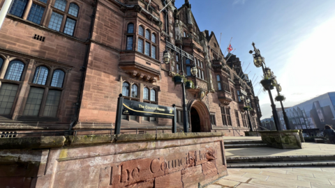 The headquarters of Coventry City Council, an ornate sandstone building with lead lined windows. The words The Council House are on the front.
