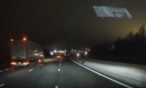 A shot from a driver's dash cam of a motorway at night. 