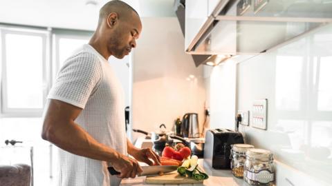 Man cooking in a kitchen.