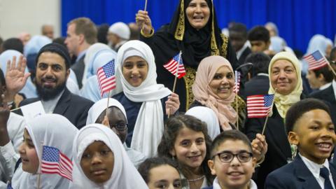 Children from the school smile at President Obama