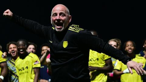 Pat Lyons celebrating with Burton players after they avoided relegation