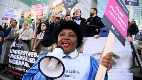 Nurses protest during a strike by NHS medical workers outside University College London Hospital in London